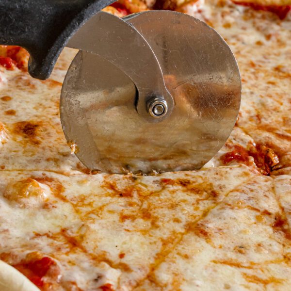 Pizza being cut